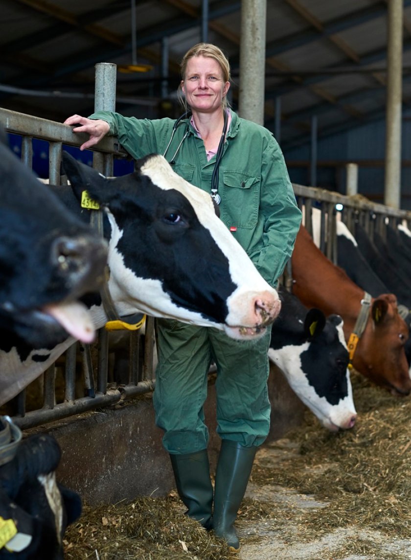 Ingrid van Dixhoorn standing between cows